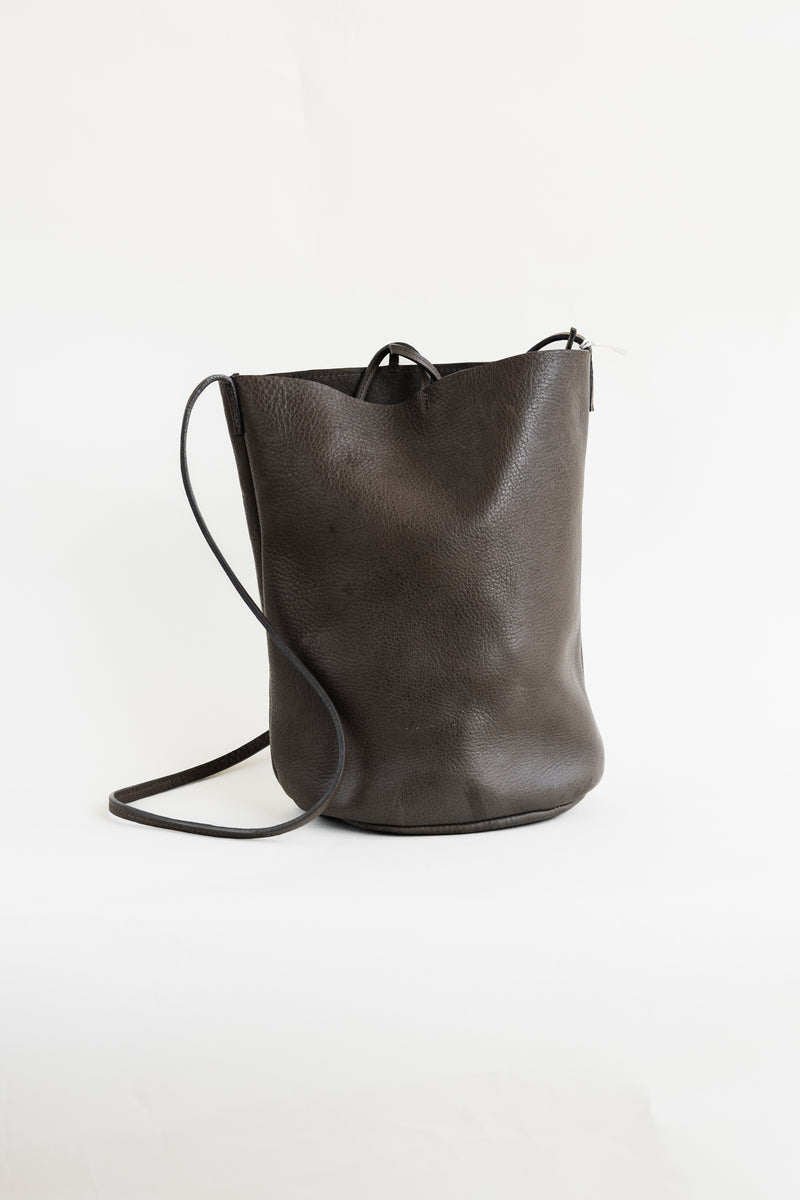 Soft, thick Argentinian leather bag with top tie and a long strap