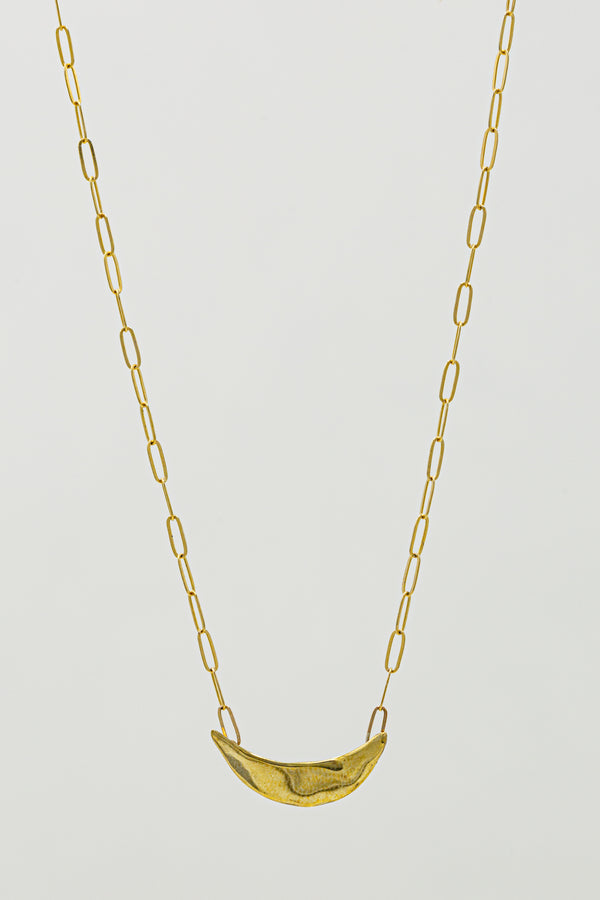 Textured brass crescent moons in brass hang on a delicate link chain necklace