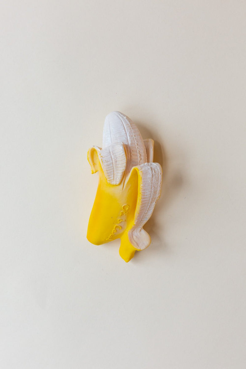An Oli & Carol Ana Banana teething toy made of all natural rubber