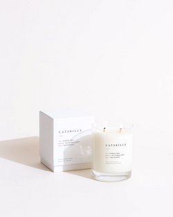 A jar of Catskills scented candle from the Brooklyn Candle Studio Escapist Collection
