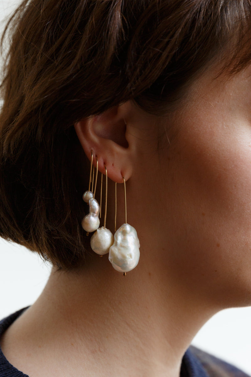 Woman wearing Moon+Arrow's pearl drop earrings with gold-fill wire