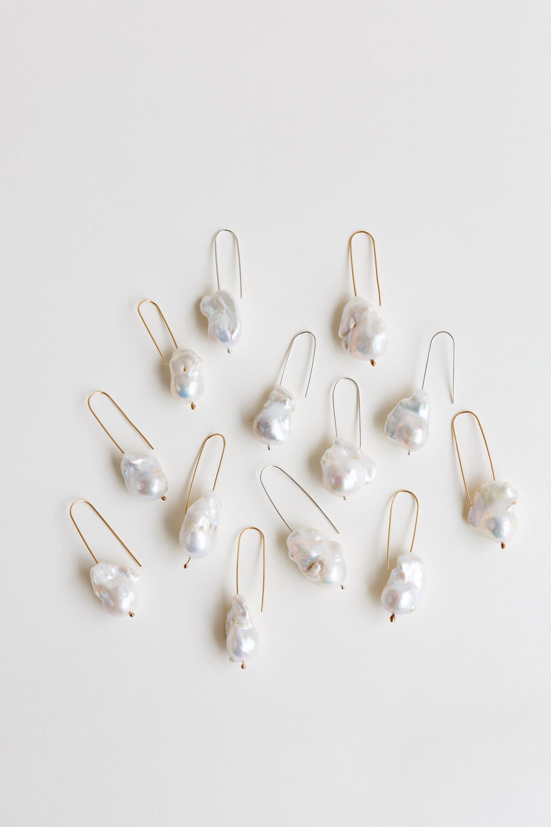 Collection of Moon+Arrow's pearl drop earrings in gold-fill and silver wire