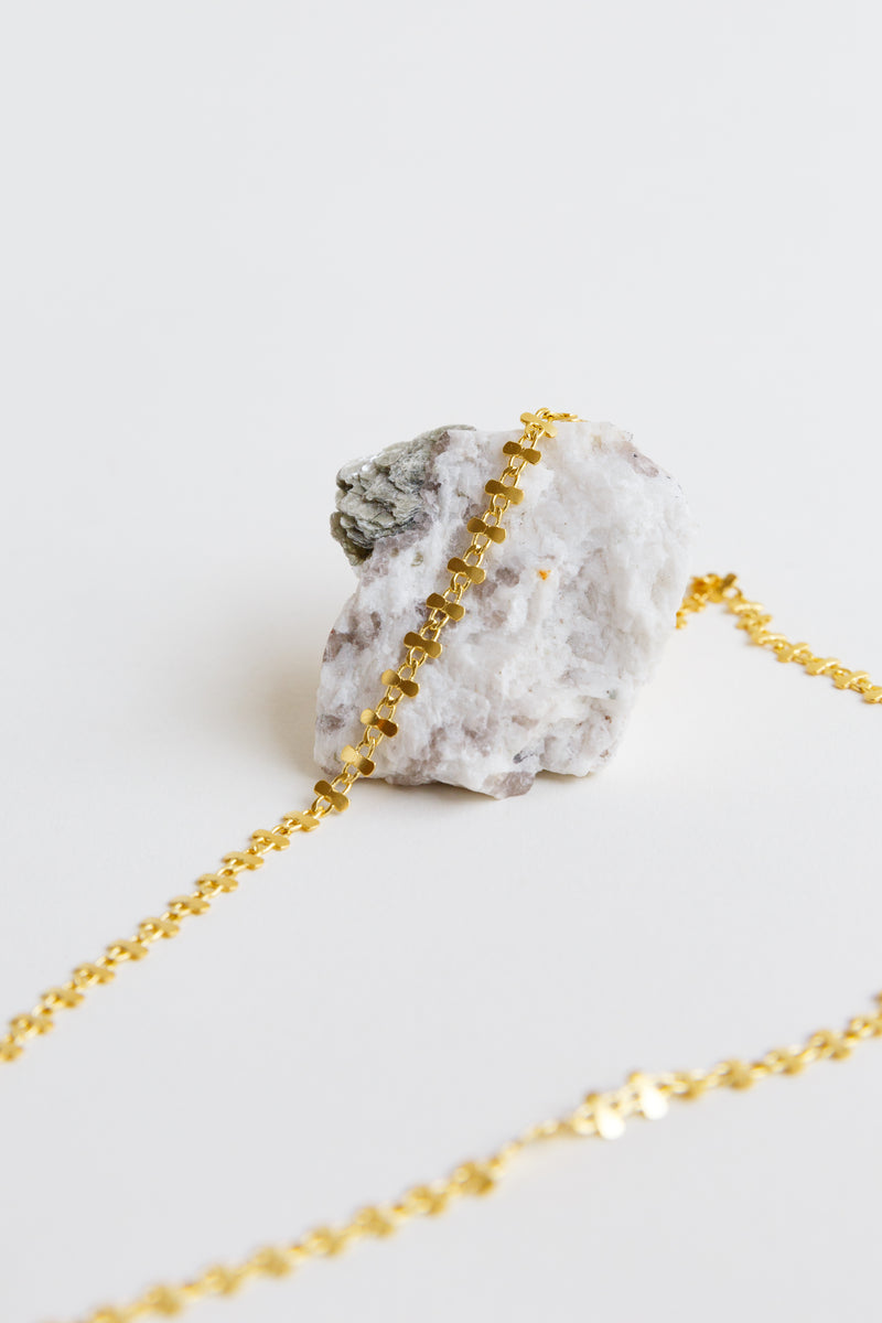 Satomi Sora Necklace laying over a rock