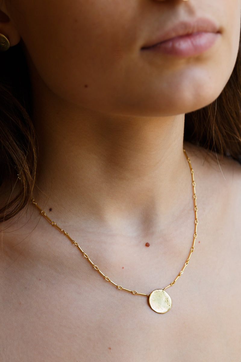 Woman wearing Moon+Arrow's full moon necklace