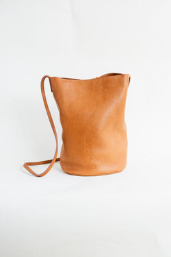 Soft, thick Argentinian leather bag with top tie and a long strap