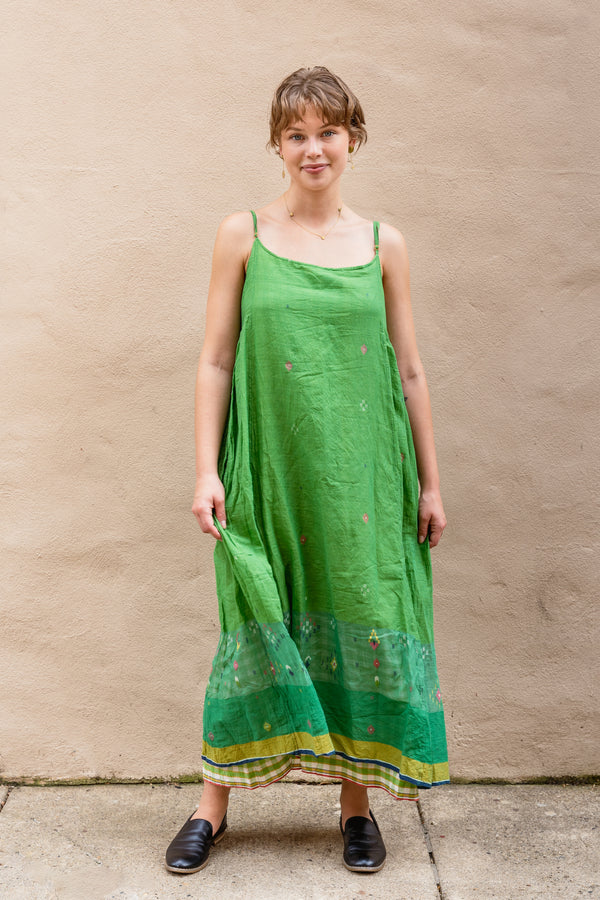 Woman wearing a beautiful green Injiri Rasa dress