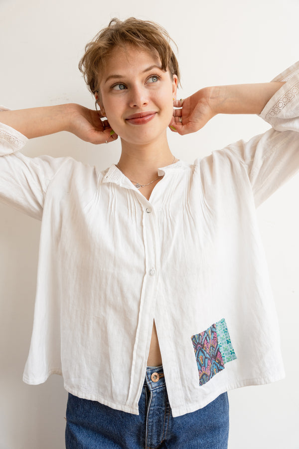 Person wearing a long sleeve antique Half Skein blouse with color patches