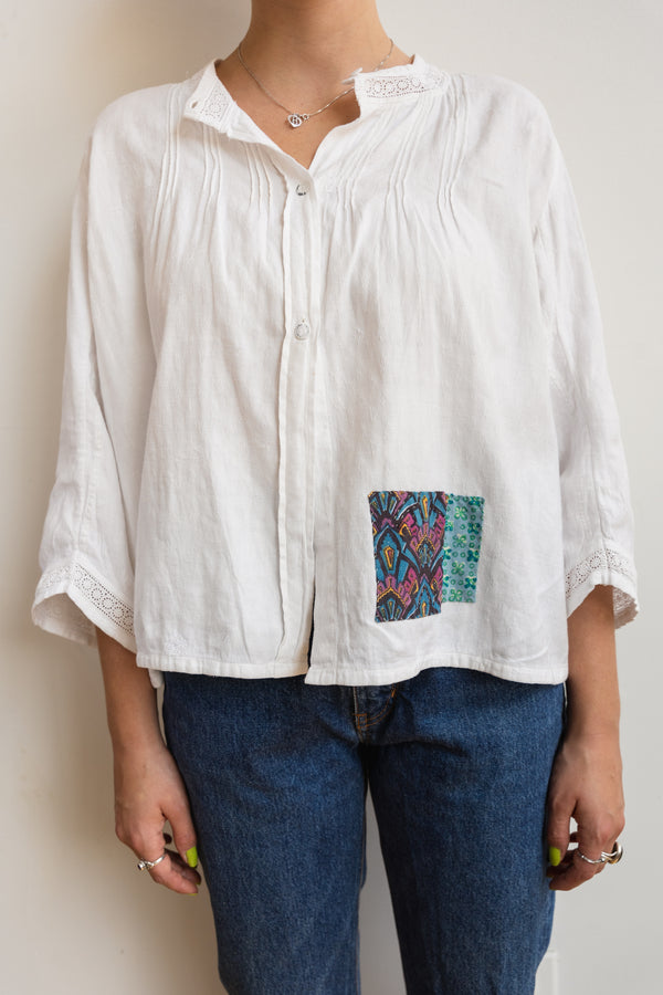 Person wearing a long sleeve antique Half Skein blouse with color patches
