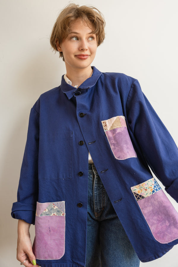 Person wearing a blue Half Skein chore jacket with purple patches