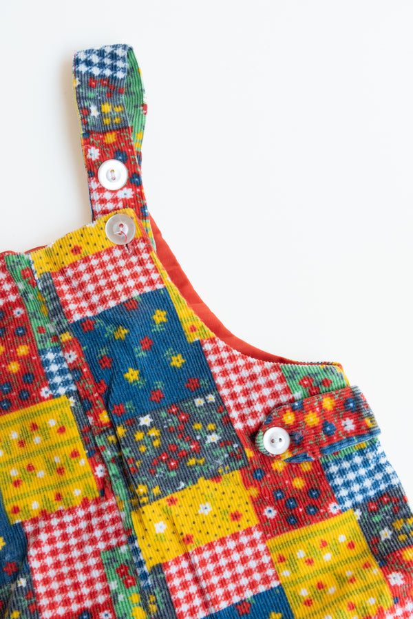 Corduroy Patchwork Overalls for kids from Gus & Way, featuring a unique multicolored patchwork design in soft corduroy fabric, with adjustable straps and practical pockets.