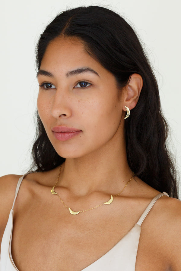 This delicate link chain necklace features triple crescent moons made of textured brass