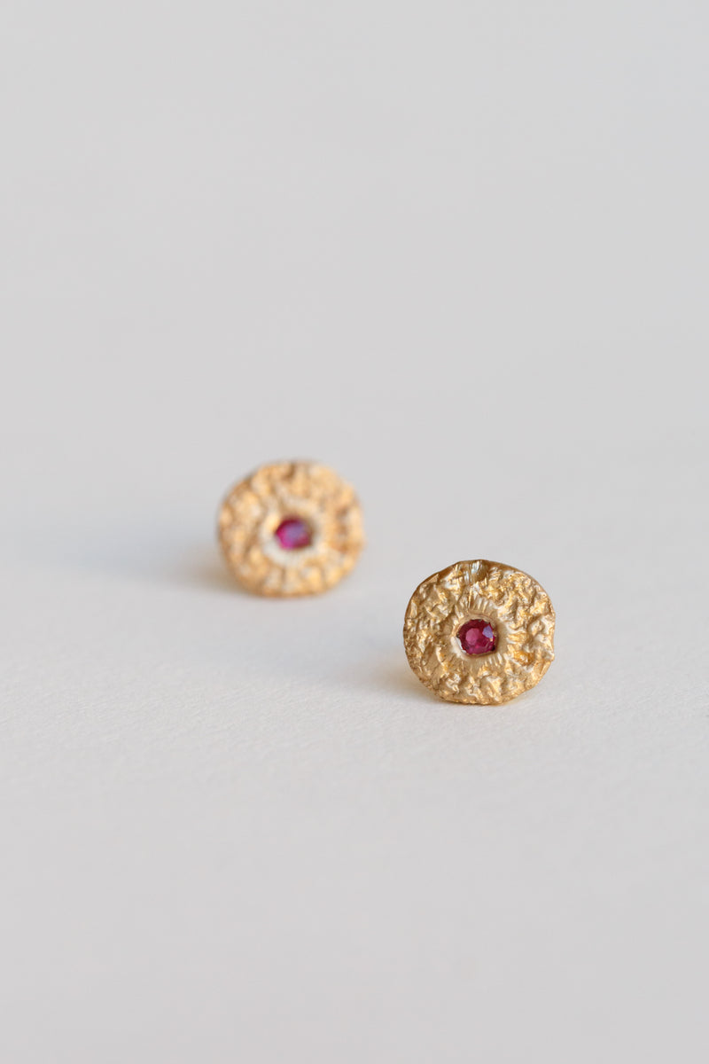 Handcrafted in New York City by 8.6.4 in 14k gold and adored with rubies, these studs are uniquely beautiful