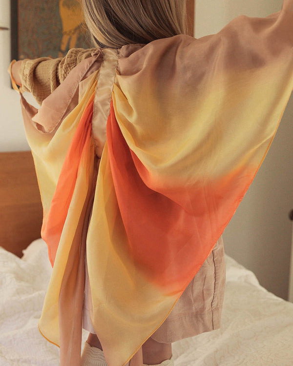 Child wearing Sarah's Silks Wings in orange and yellow