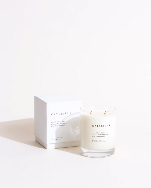 A jar of Catskills scented candle from the Brooklyn Candle Studio Escapist Collection