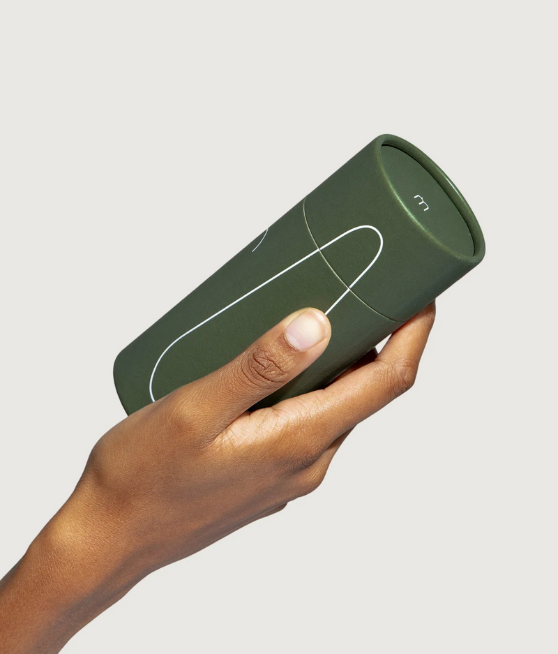 A person holding a package with a Maude Vibe Personal Massager