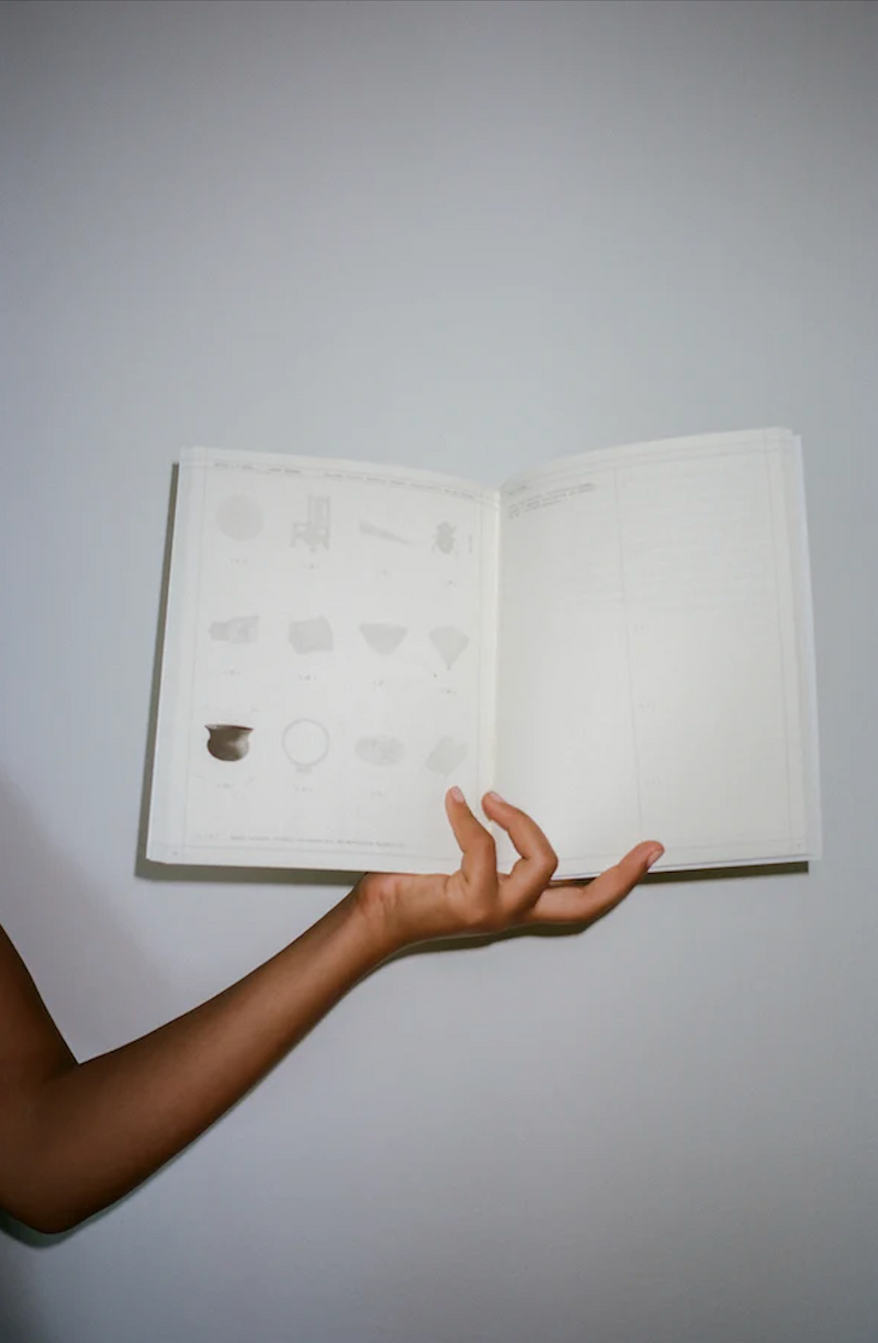 Person holding a Moon List Workbook 02