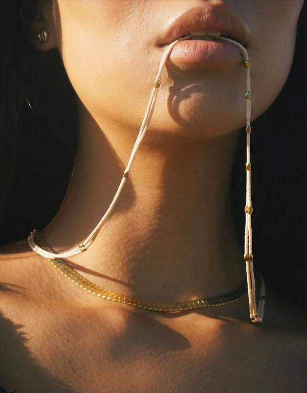 Person biting on a Satomi Double Strand Necklace