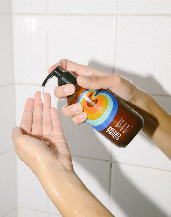 A person holding a bottle of Bathing Culture Good Seed Conditioner