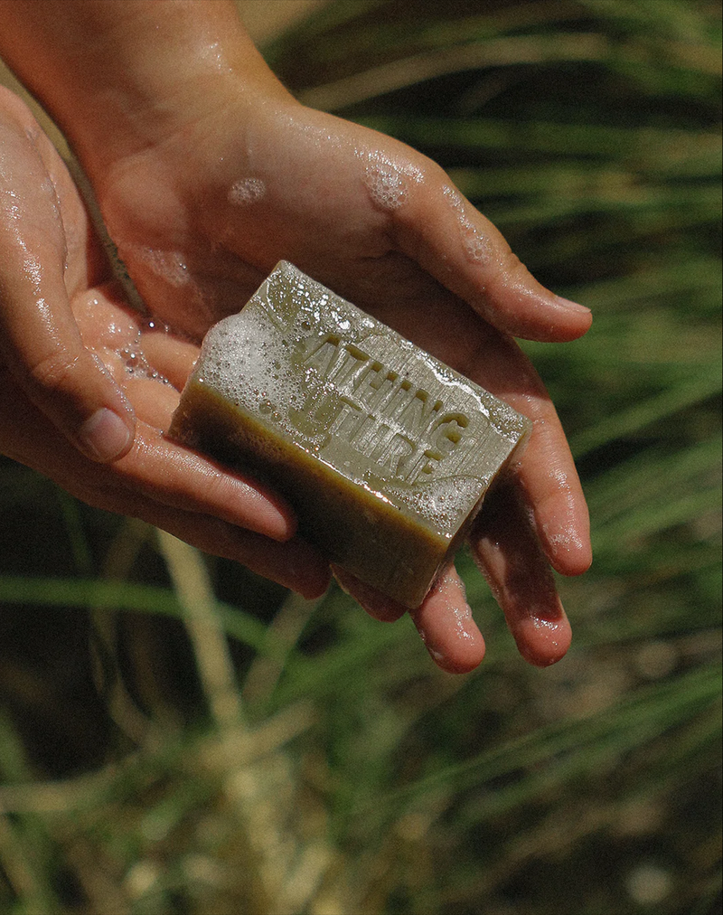 A person holding a bar of Bathing Culture Mind & Body Bar