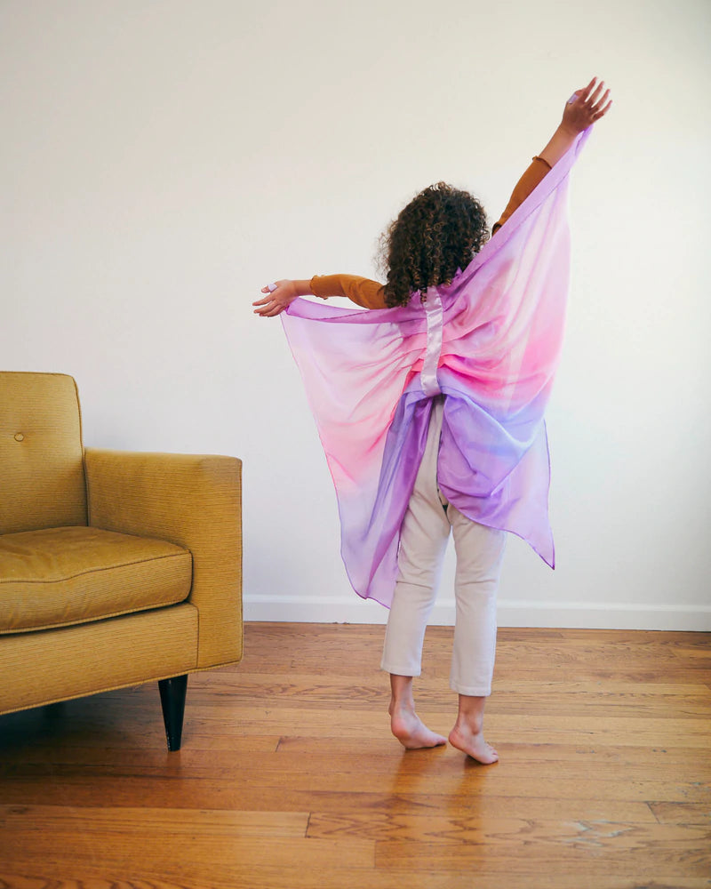 Child wearing Sarah's Silks Wings in purple and pink