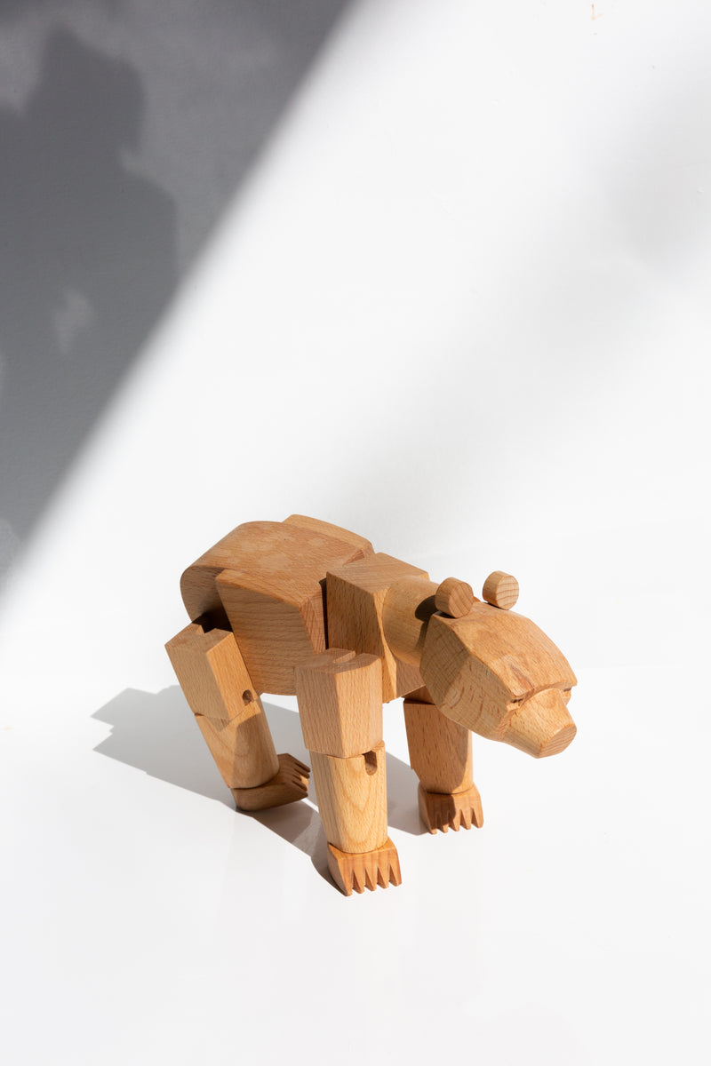 Areaware Ursa Minor wooden bear toy perched upon a table top