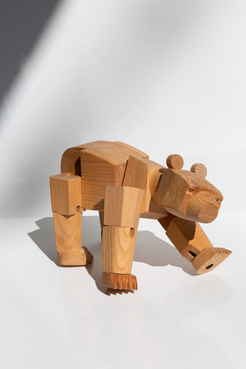 Areaware Ursa Minor wooden bear toy perched upon a table top