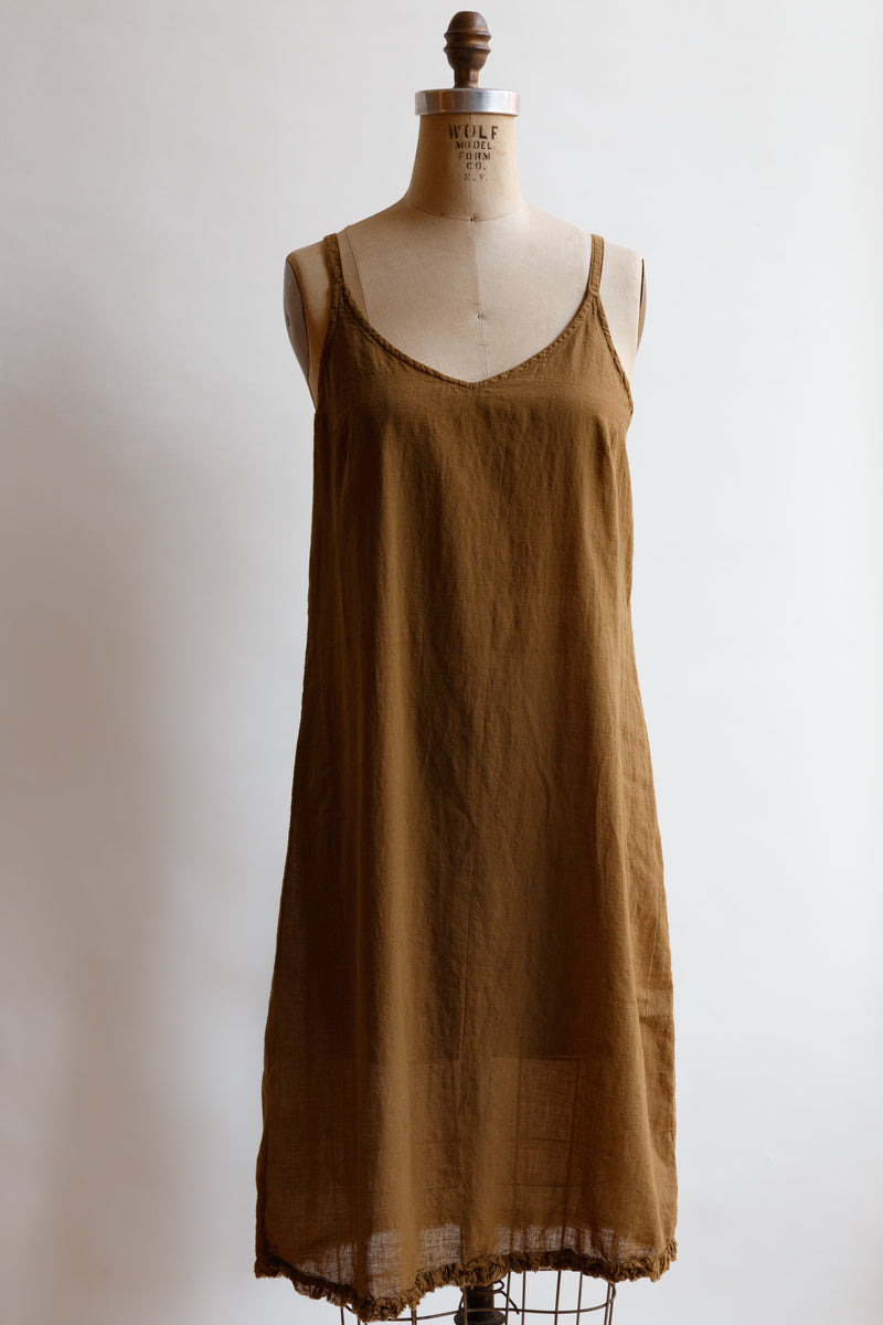 Handcrafted in India by weaver artisans using hand-spun yarn, this light weight toffee slip by Auntie Oti is on display on a mannequin