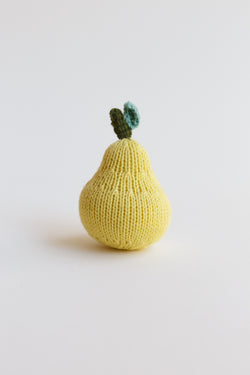 A collection of blabla fruit rattles, apple, pear, and cherries, made of 100% cotton knit and handmade in Peru