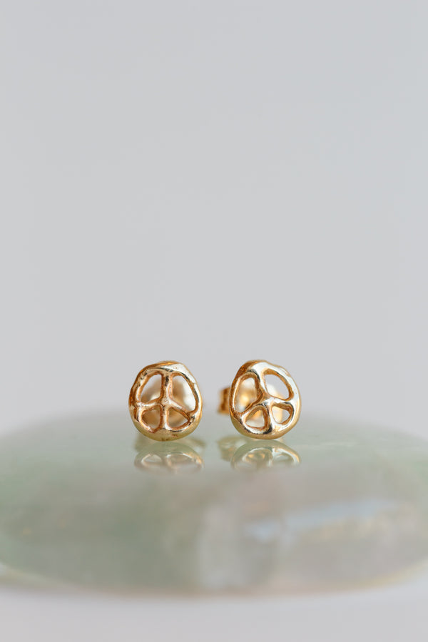Emilie Shapiro peace sign stub earrings made with 14k recycled gold