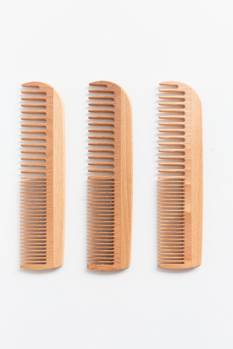 A collection of Heaven In Earth combs, beech wood combs designed to protect hair's natural beauty by reducing damage and breakage to hair