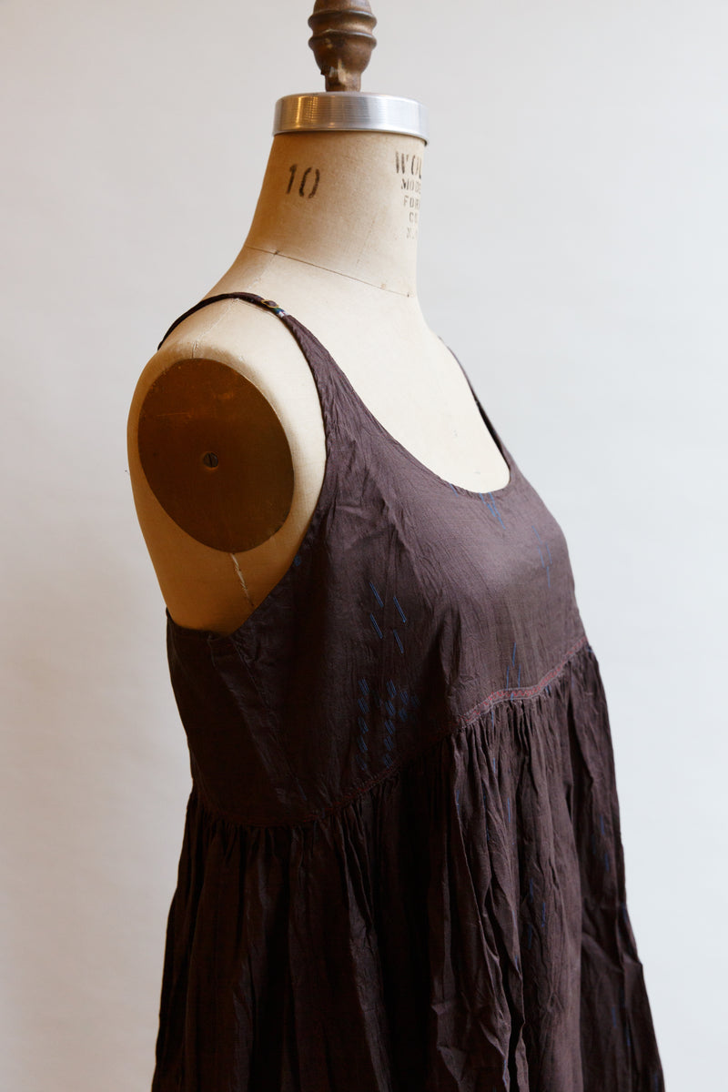 Made of 100% silk, this beautiful Inijiri slip dress, on display on a mannequin, is handwoven in India by incredible craftspeople
