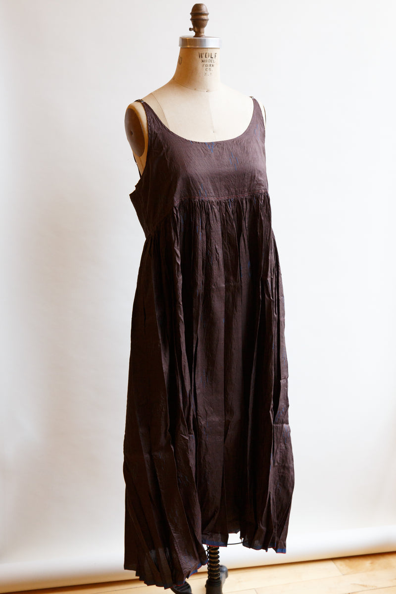 Made of 100% silk, this beautiful Inijiri slip dress, on display on a mannequin, is handwoven in India by incredible craftspeople