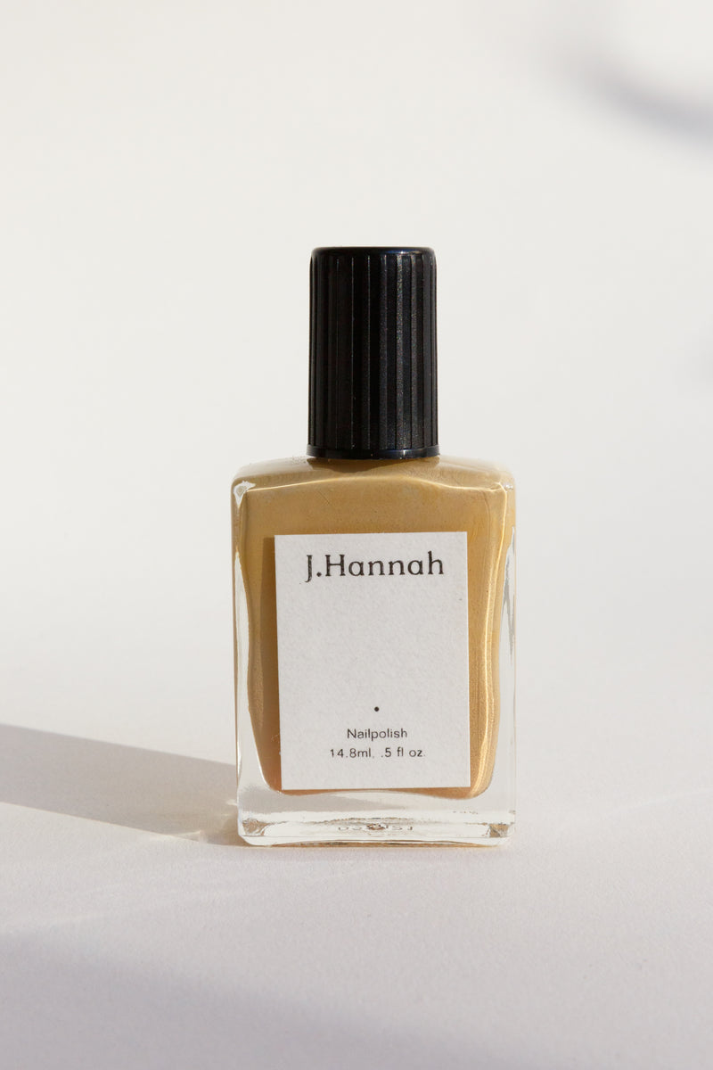 A bottle of yellow nail polish by J.Hannah