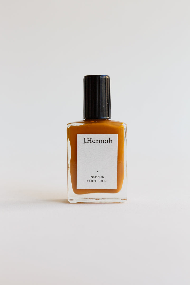 A bottle of orange nail polish by JHannah nail polish