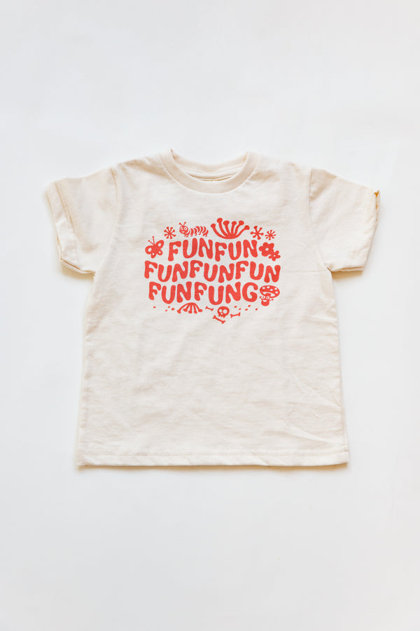 A baby Joan Ramone fun fun fungi t-shirt, handprinted on super soft 100% organic cotton with non-toxic, waterbased ink, laying flat on a table