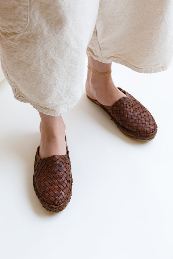 Person wearing a pair of Mohinders Woven Slide shoes in Walnut