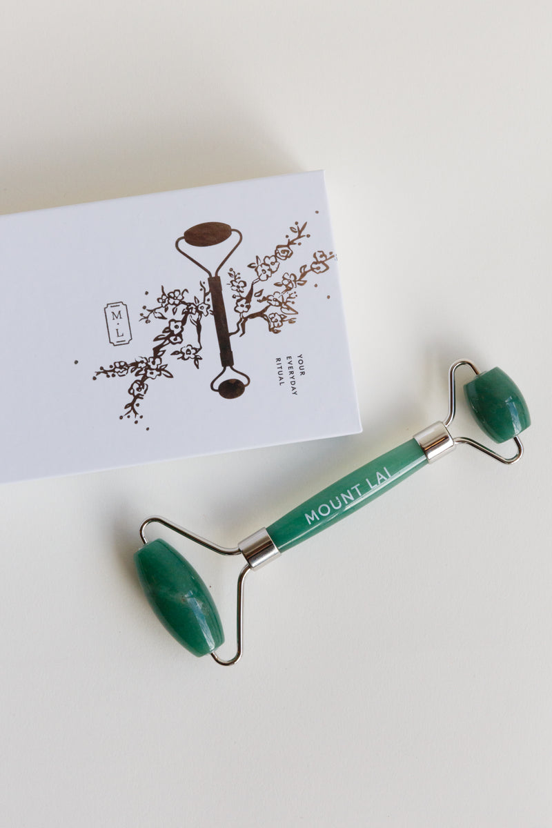 A green Mount Lai Facial Roller, a Chinese skincare tool that has been used for thousands of years
