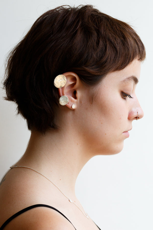 Person wearing Moon+Arrow's new moon stud earrings in sterling silver