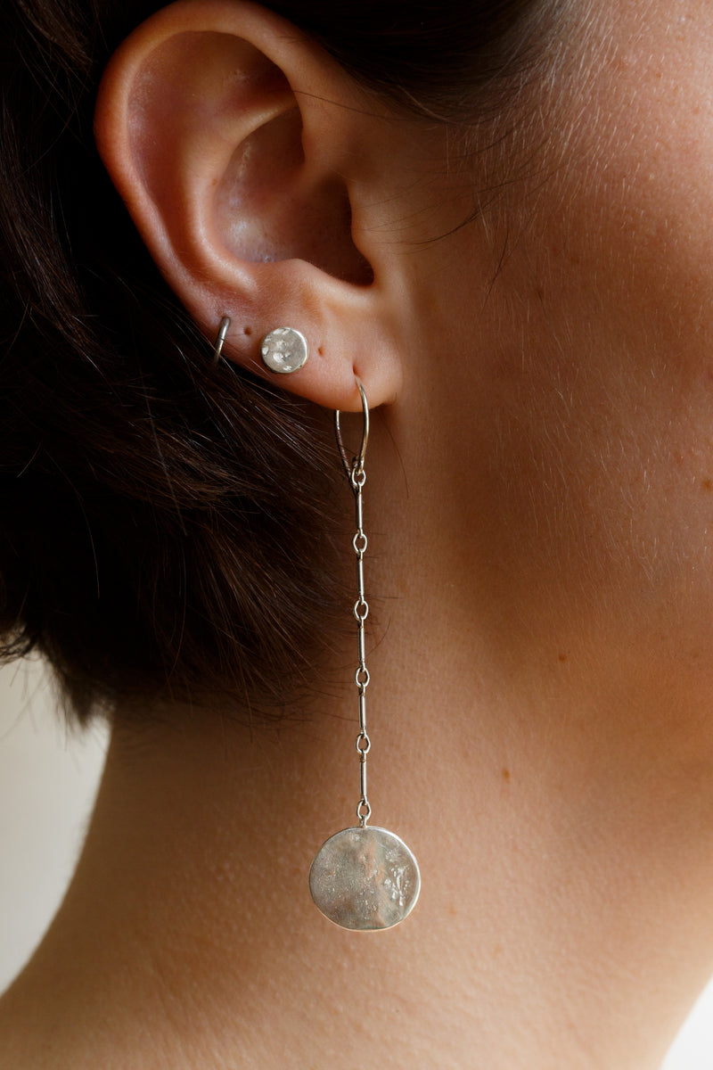 Person wearing Moon+Arrow's swaying new moon earrings