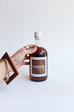 Person holding a bottle of Gnista Barreled Oak mixer