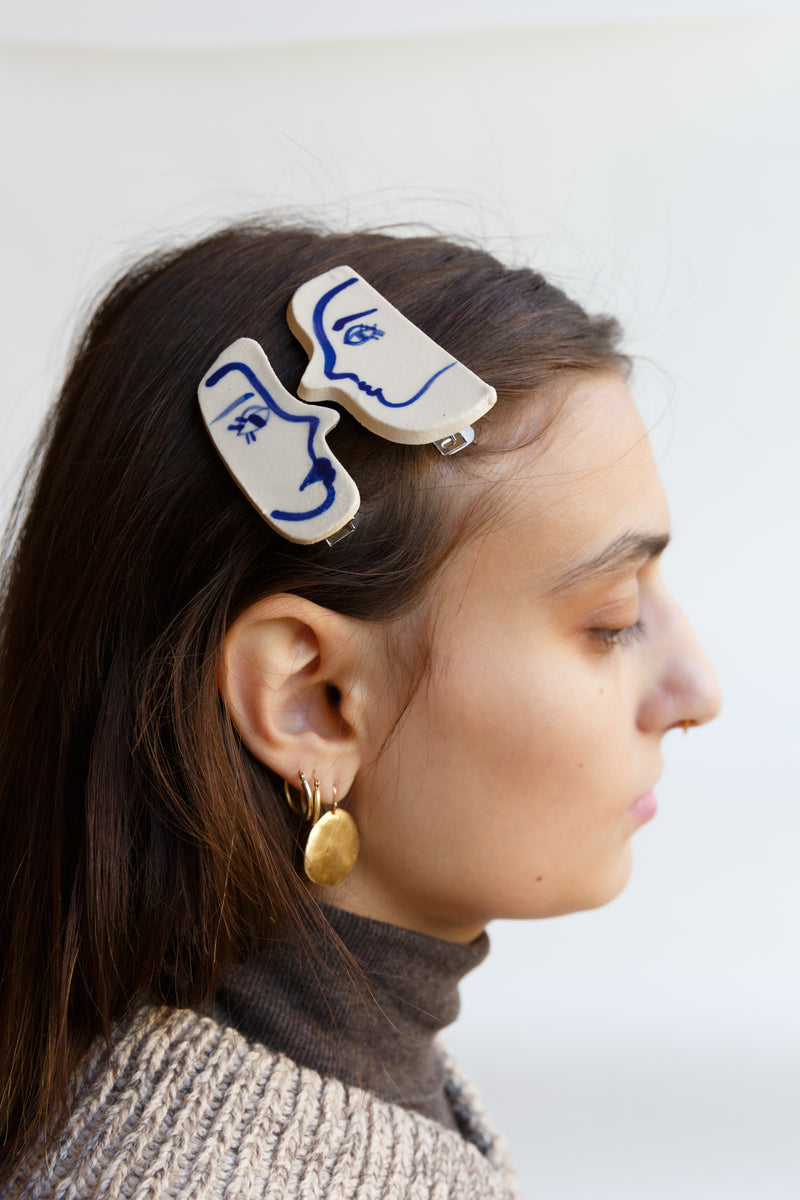 A person wearing the Blue Dancer Hair Clip handcrafted by ceramicist Rex Design