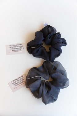 Two blue-colored Rosemarine scrunchies made with silk organza and dyed using plant matter and organic materials in Detroit