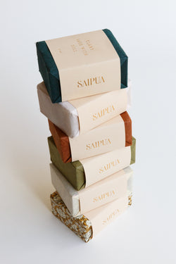 A stack of beautiful handcrafted Saipua Soaps made in New York and wrapped in beautiful handmade paper