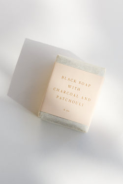 A bar of Saipua black soap with charcoal and patchouli