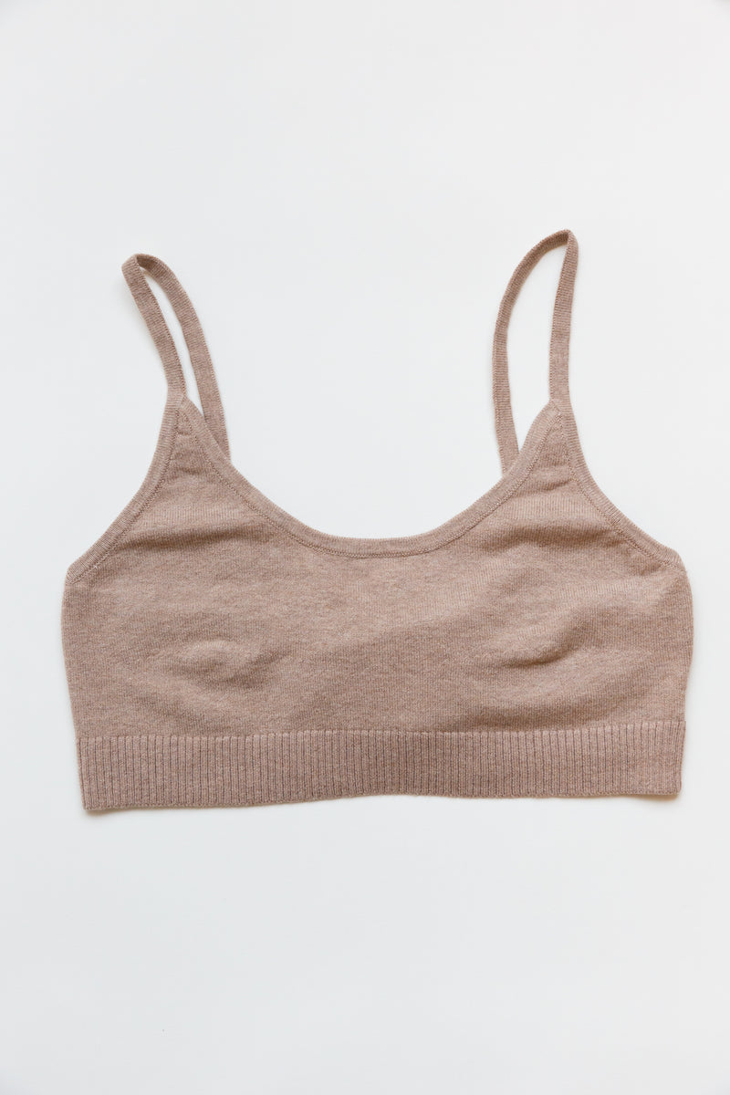A cotton silk sporty bralette with bottom ribbing laying on a flat table