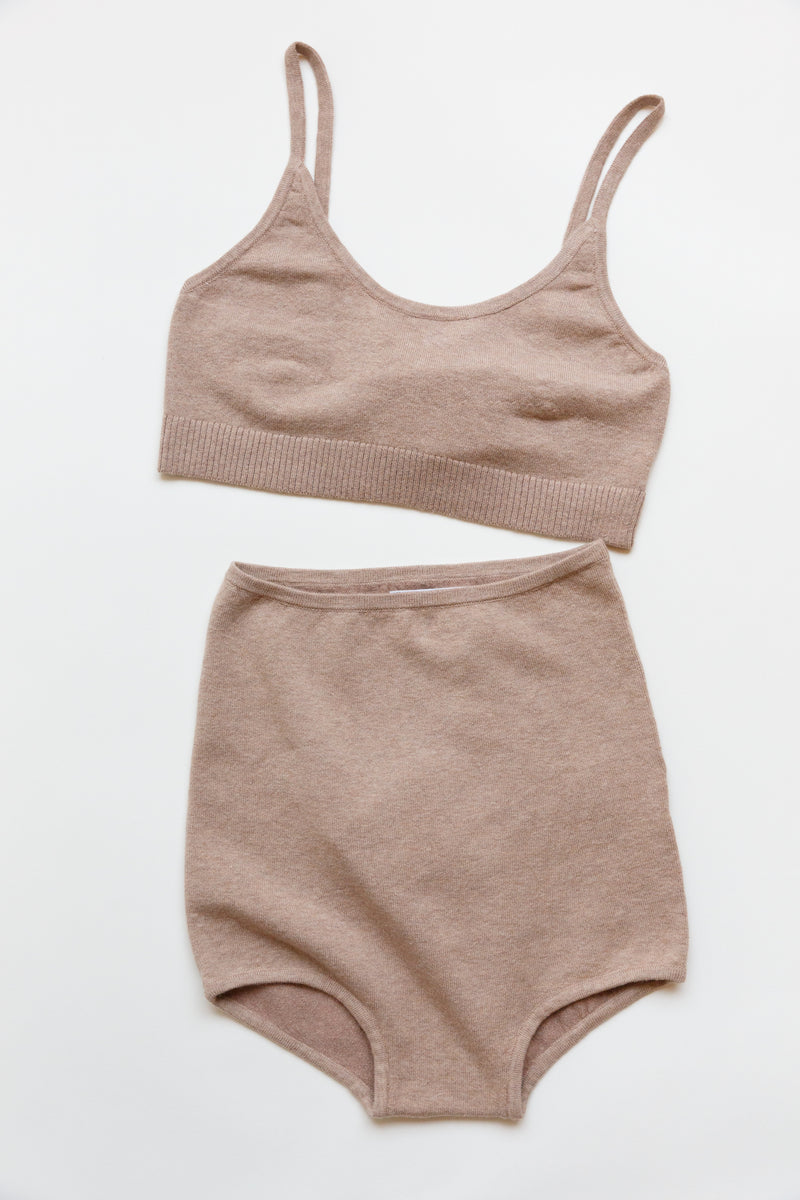 A cotton silk sporty bralette with bottom ribbing laying on a flat table
