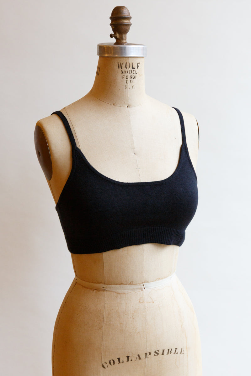 A black cotton silk sporty bralette with bottom ribbing on display on a mannequin