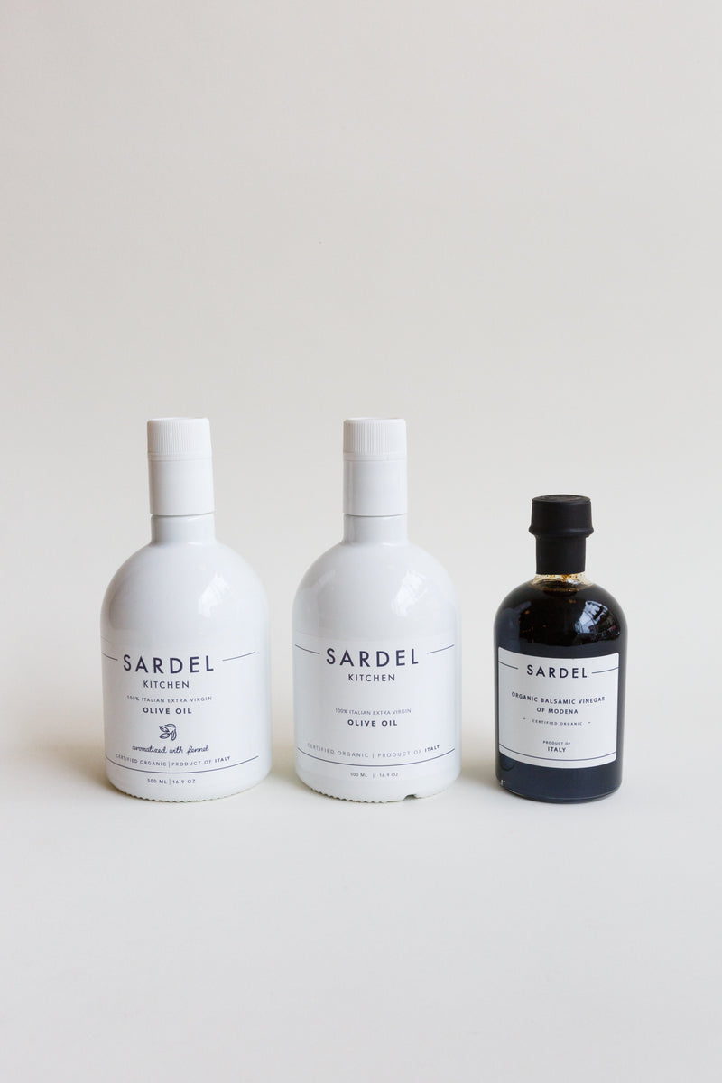 Bottle of Sardel Organic Balsamic Vinegar alongside bottles of olive oil