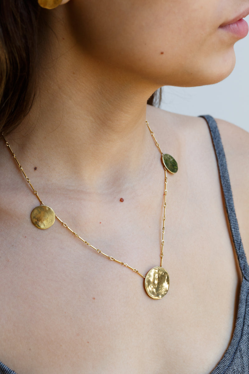 Woman wearing Moon+Arrow's triple full moon necklace