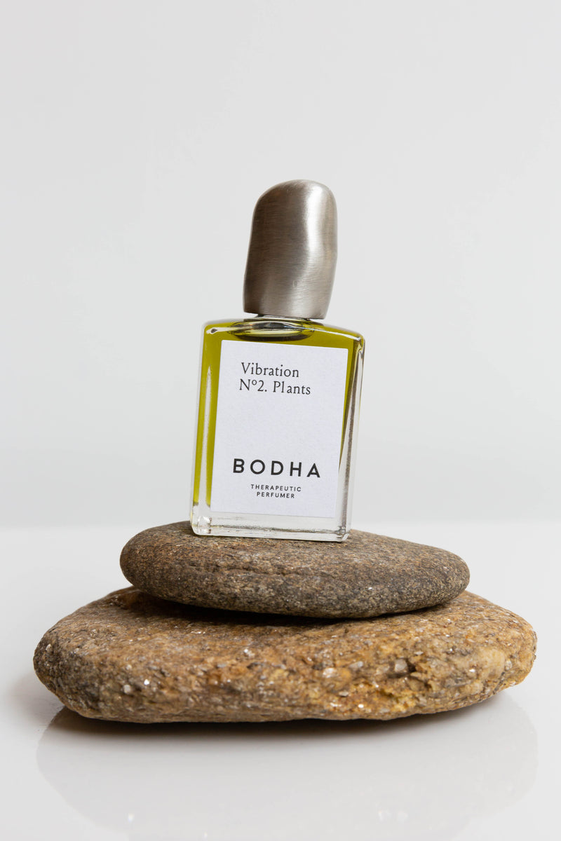A bottle of Bodha Natural Perfume Oil, roller bottles with hand-cast bronze lid, made in Los Angeles with vegan and sustainably sourced ingredients